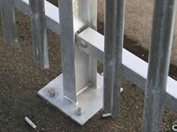 RSJ palisade fencing post with base plate are bolted to the ground